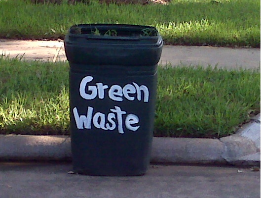Trash can with "green waste" painted on it