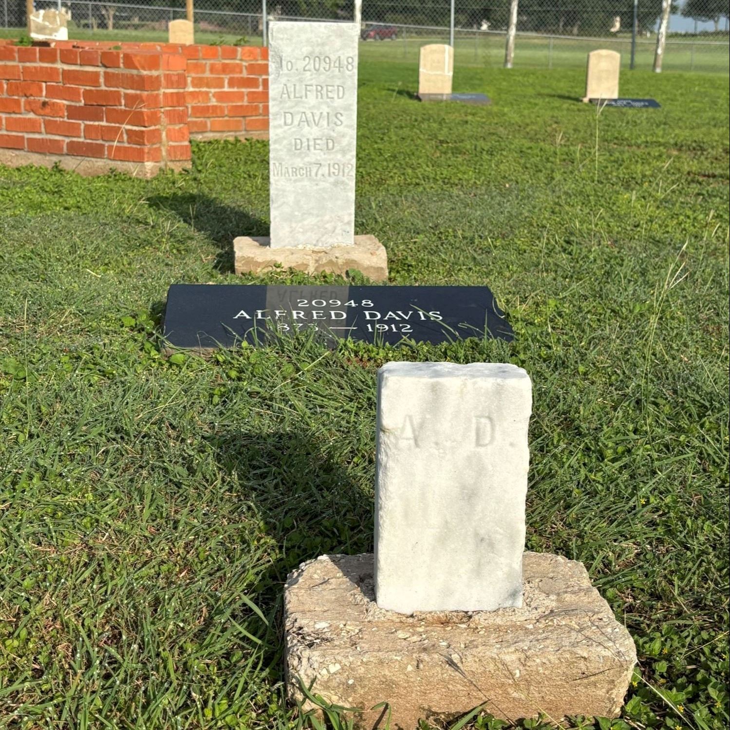 Post-Restoration of Alfred Davis's gravestone and pillow marker in 2023